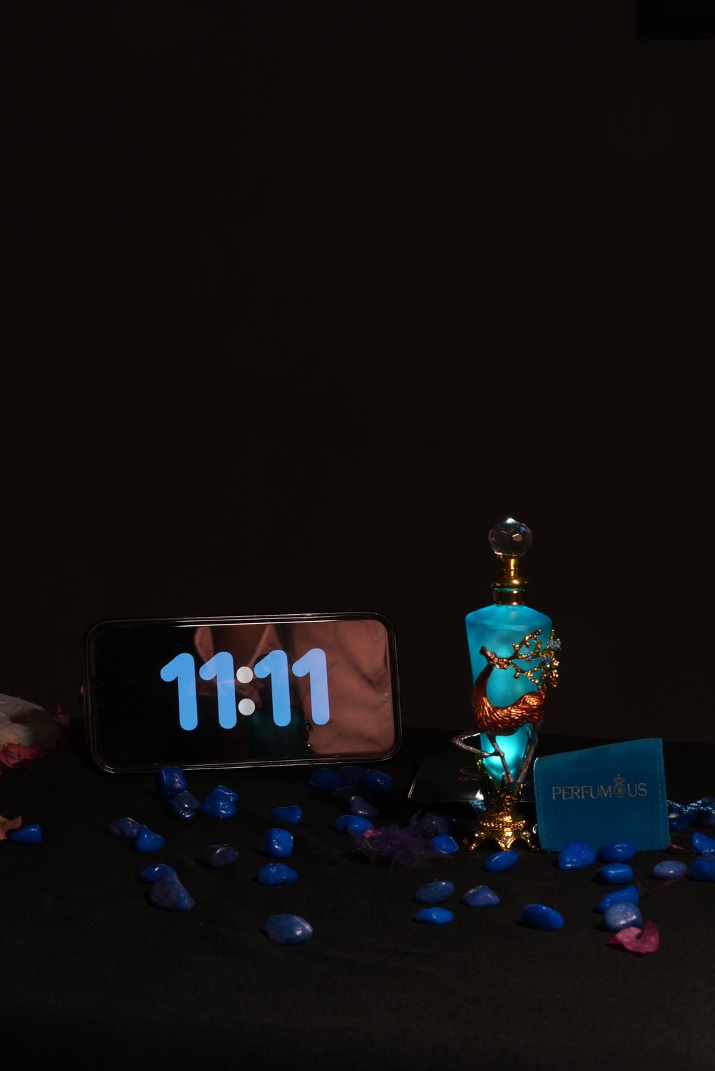 A blue-tinted designer deer bottle of 11:11 Attar by Perfumous, representing synchronicity and pure luxury.