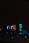 A blue-tinted designer deer bottle of 11:11 Attar by Perfumous, representing synchronicity and pure luxury.