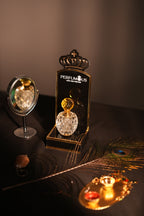 Peacock feather earring with a decorative stand featuring 'Pepinier' branding on a dark background.
