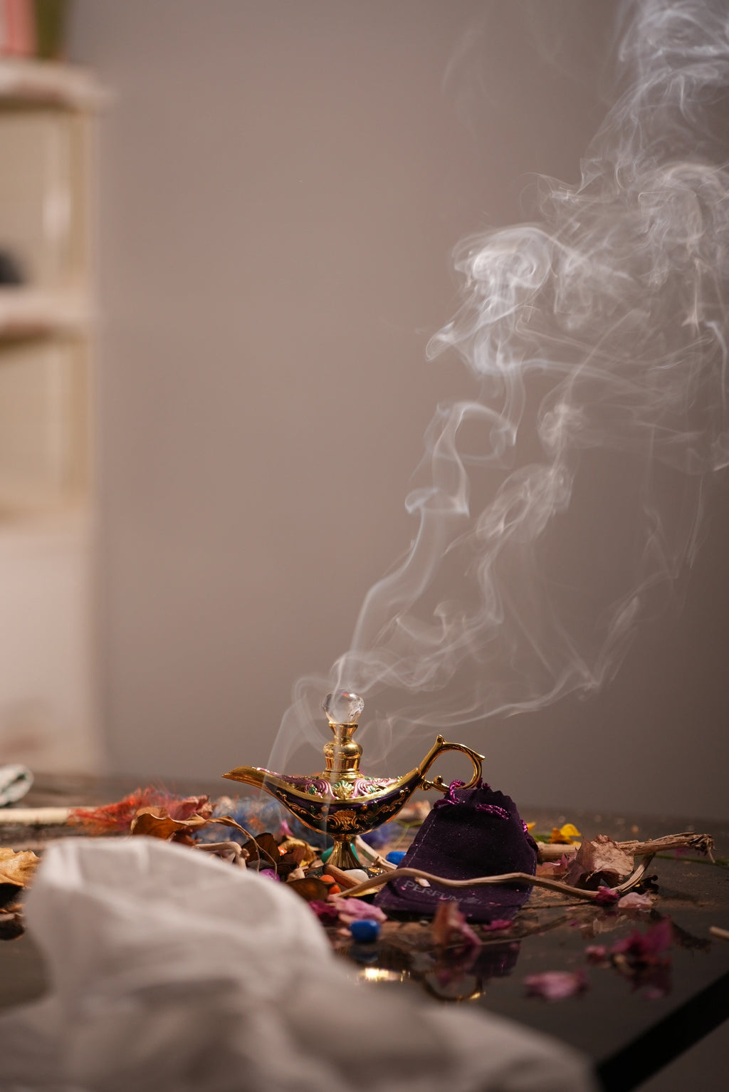 A golden designer Chirag bottle of Hundred Healer Attar by Perfumous, showing sacred smoke and artisanal detail.